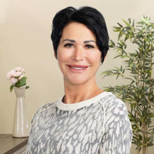 Smiling woman with short dark hair indoors