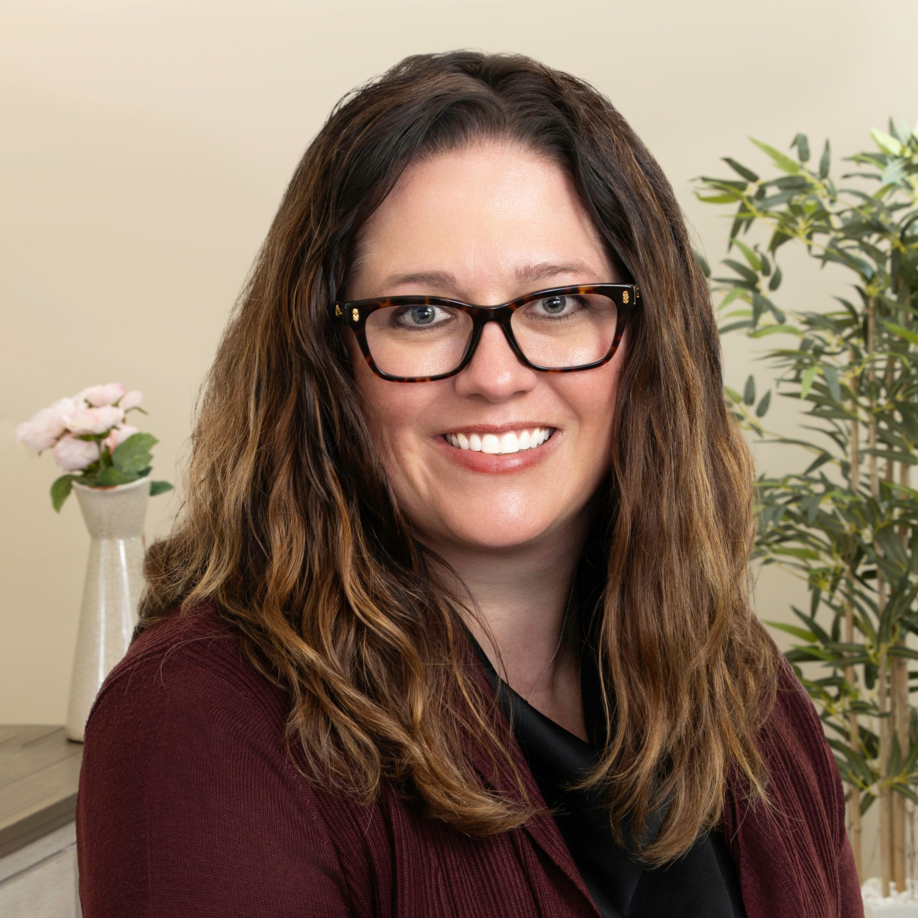 Professional woman with glasses smiling indoors
