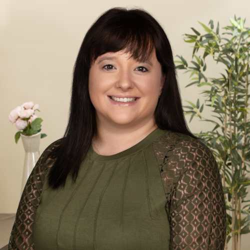 Smiling woman in green top indoors