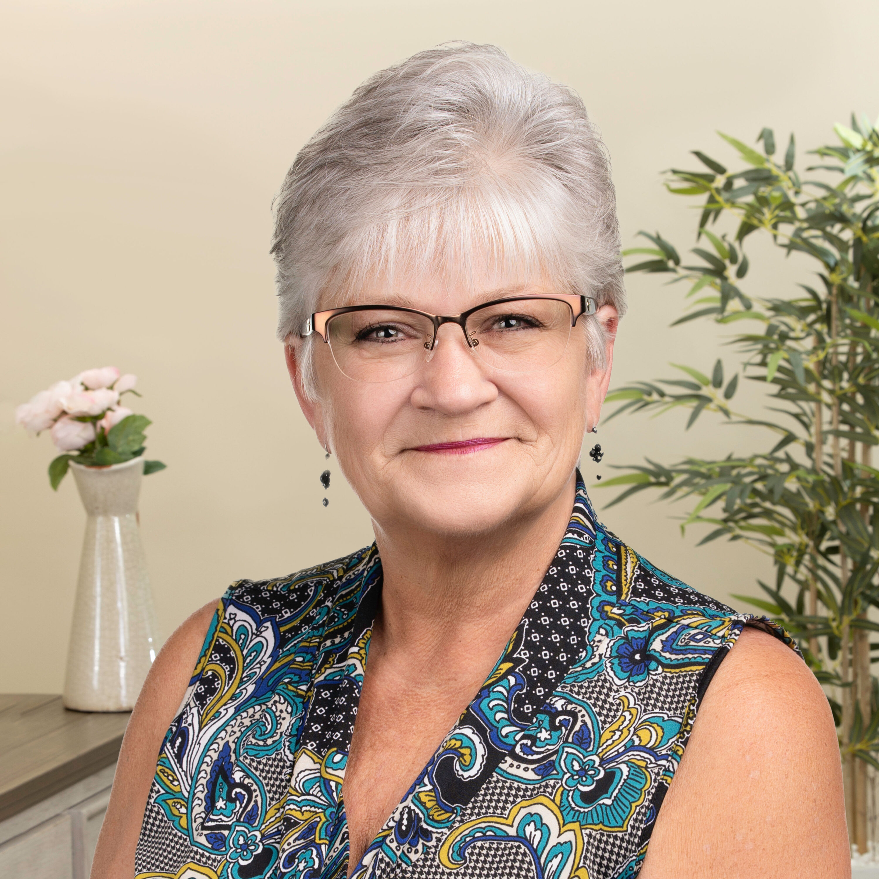 Smiling older woman with glasses indoors