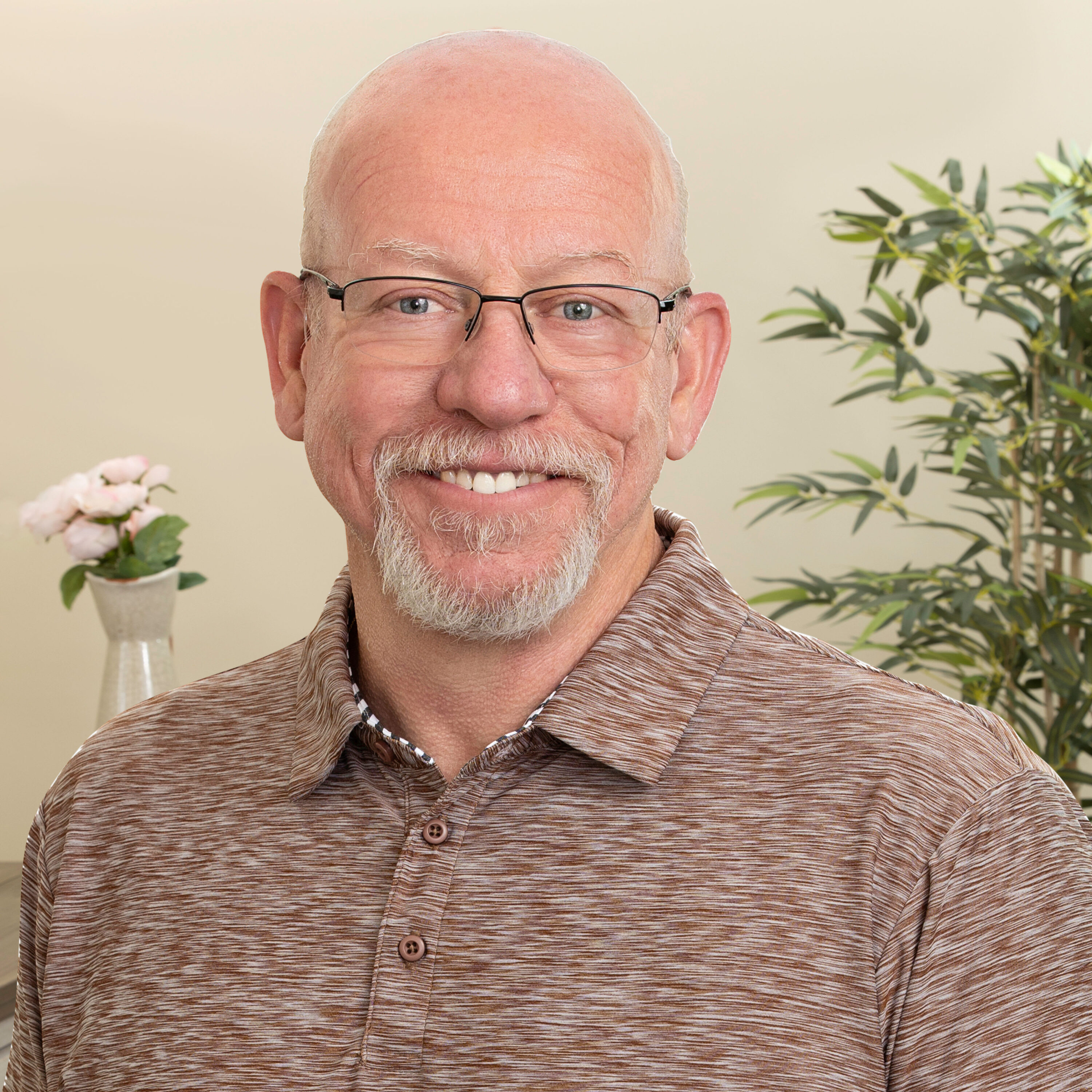 Smiling bald man with glasses indoors