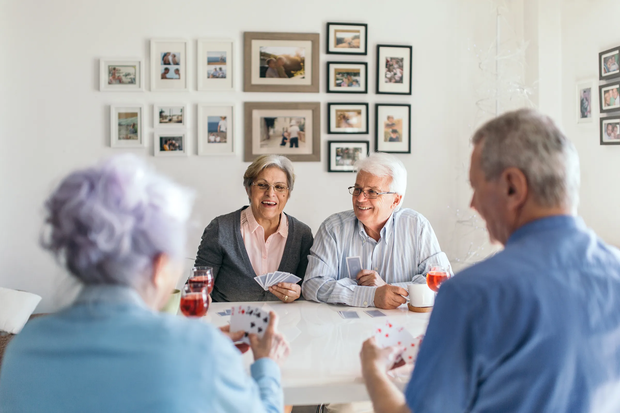 Older adults playing cards together at a table